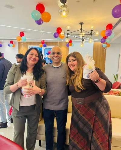 Team members celebrating together with balloons and streamers